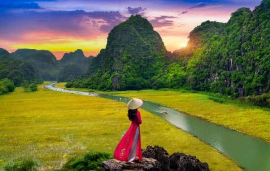 Asian woman wearing Vietnam culture traditional at Tam coc, Vietnam.