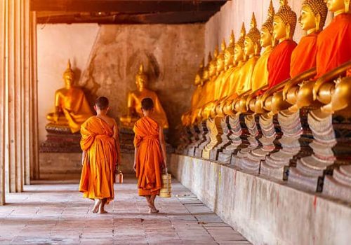 Two novices walking return and talking in old temple at sunset time, Ayutthaya Province, Thailand